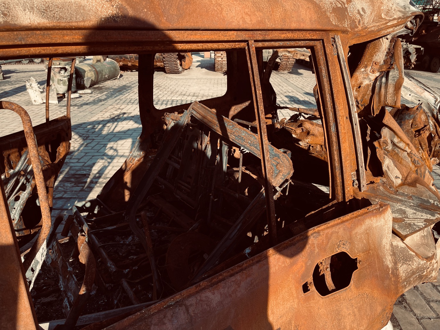 a rusted car with broken windows