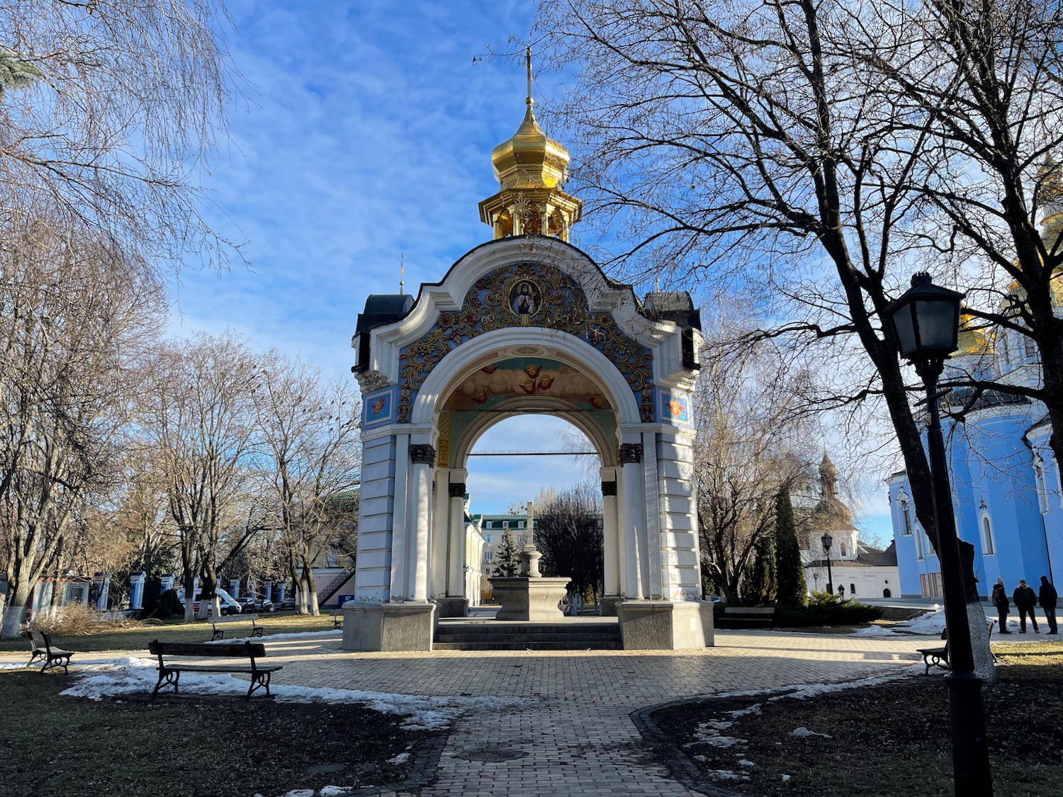 a white archway with a gold dome