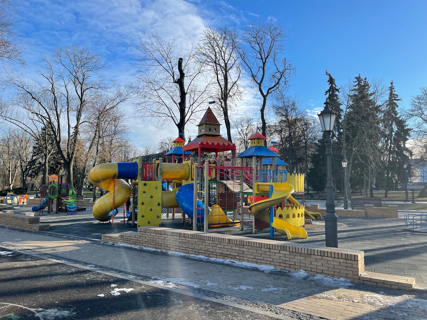 a playground with a castle and slide