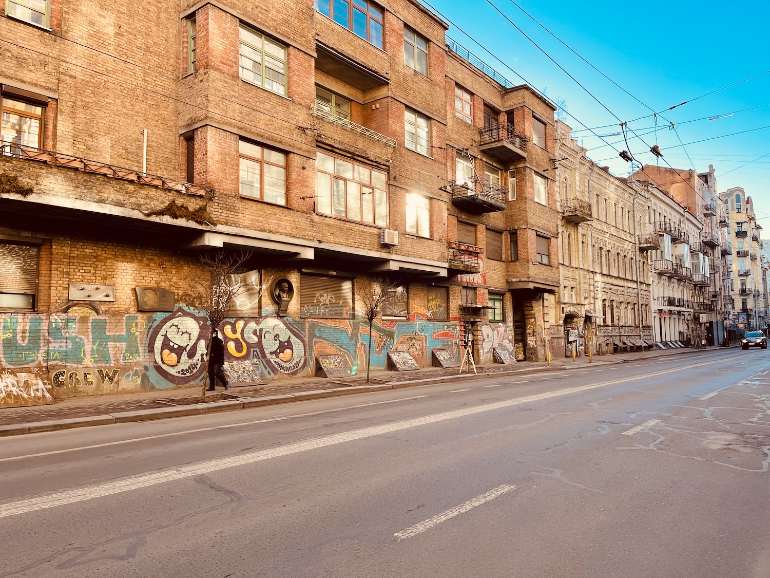 a street with graffiti on the side of a building