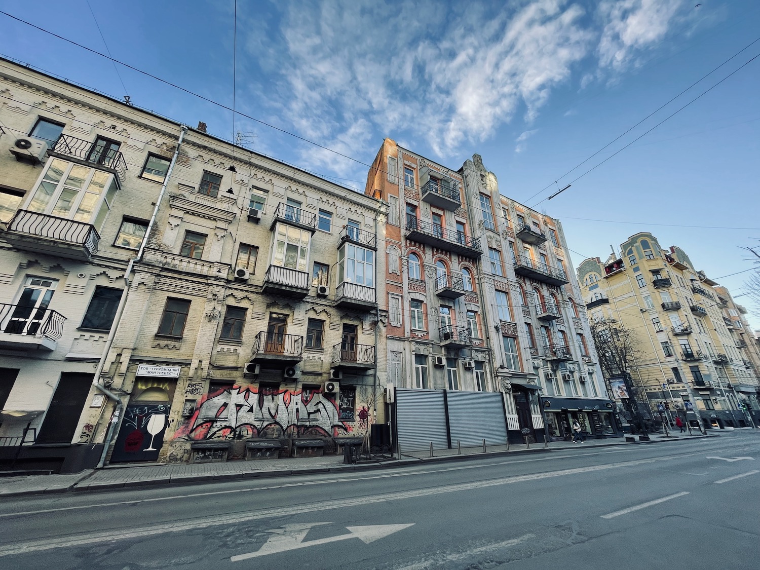 a street with buildings and graffiti on it