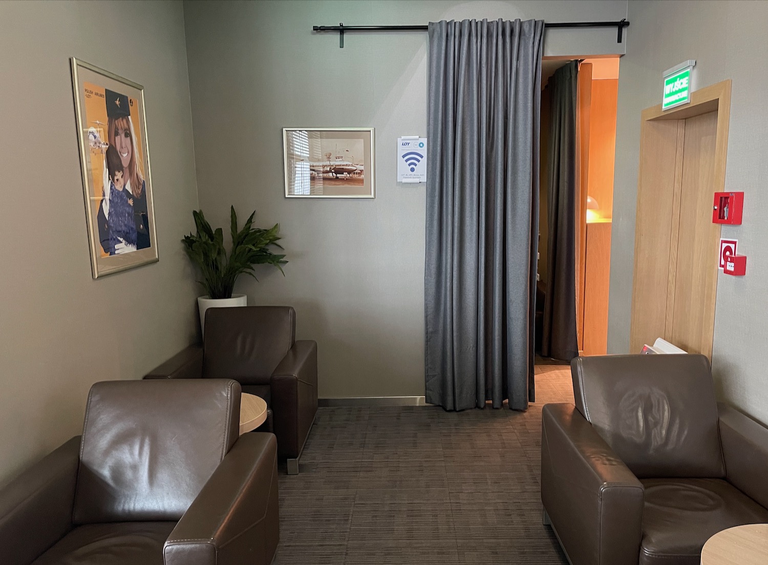 a room with brown leather chairs and a picture on the wall