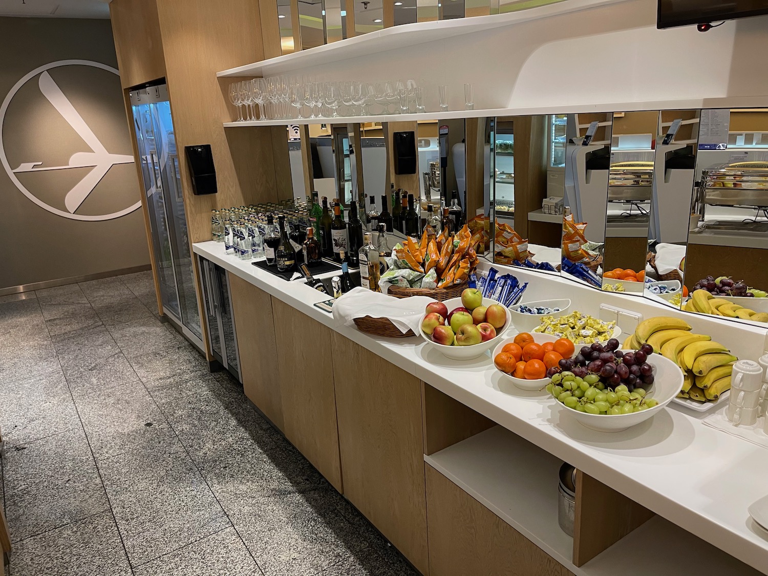 a counter with fruit and drinks on it