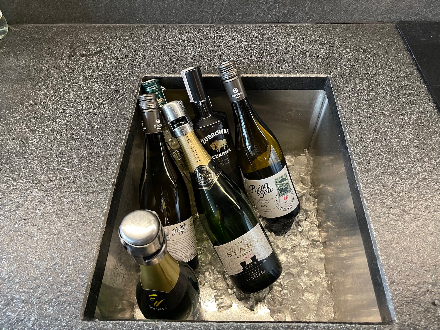 a group of bottles in a metal sink