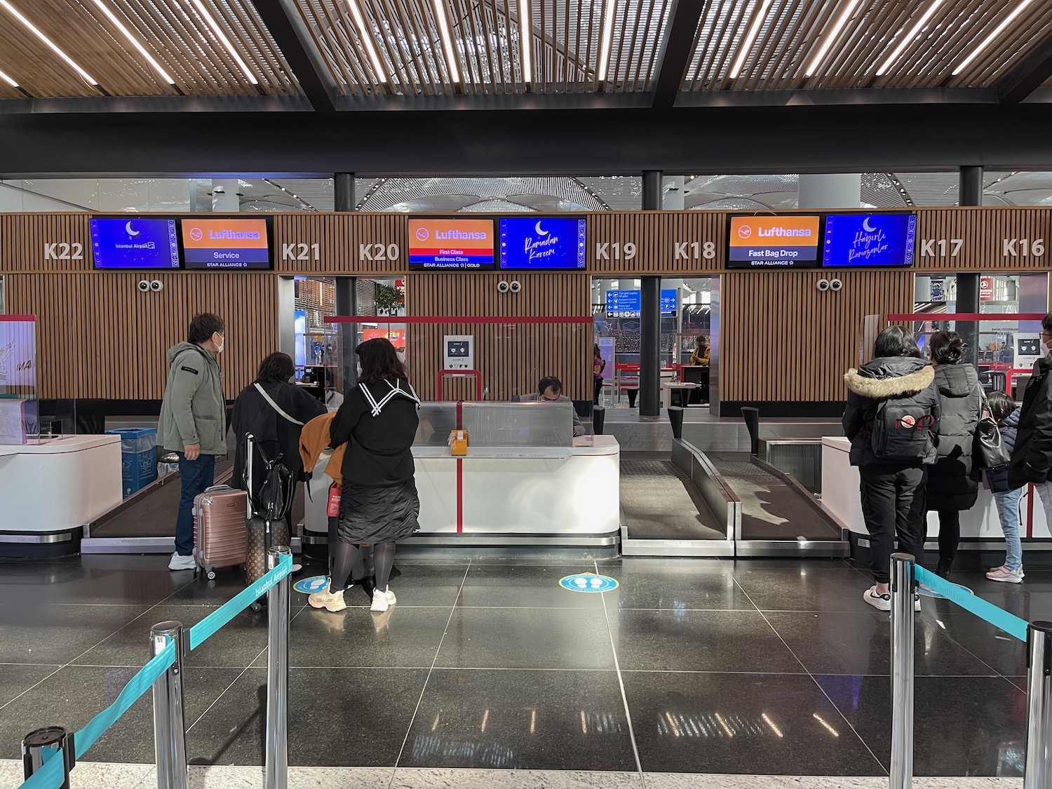 people standing in front of a check in counter