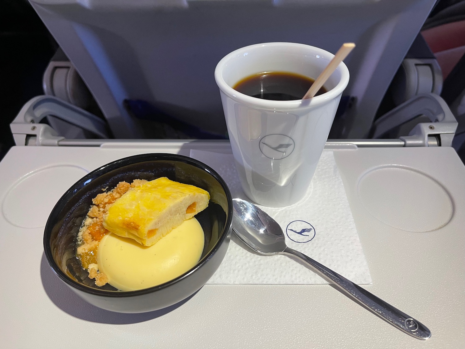 a cup of coffee and dessert on a tray