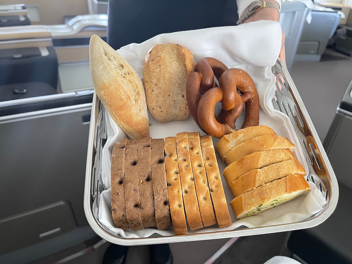 a basket of bread and pretzels