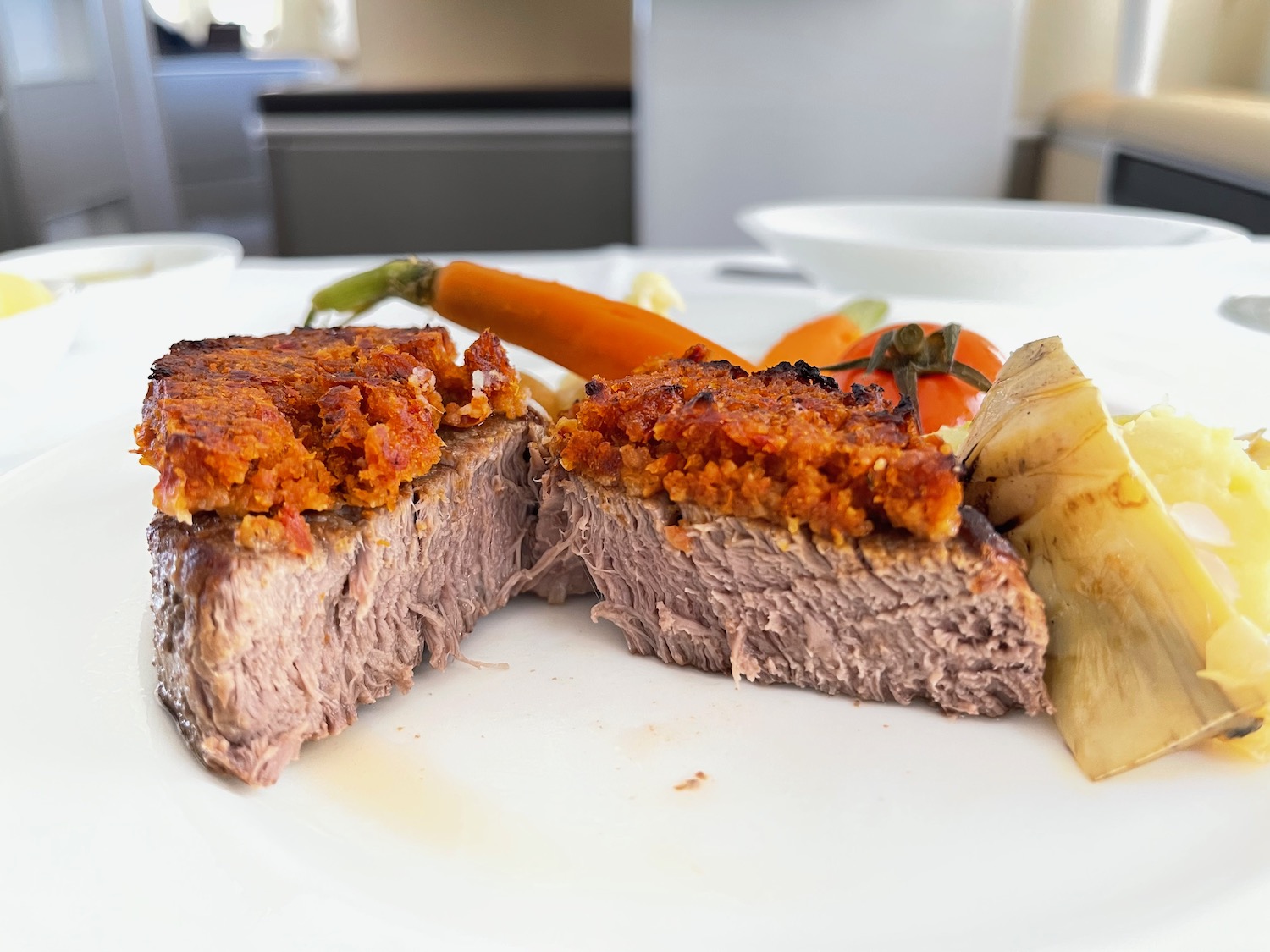 a plate of food with a piece of meat and vegetables