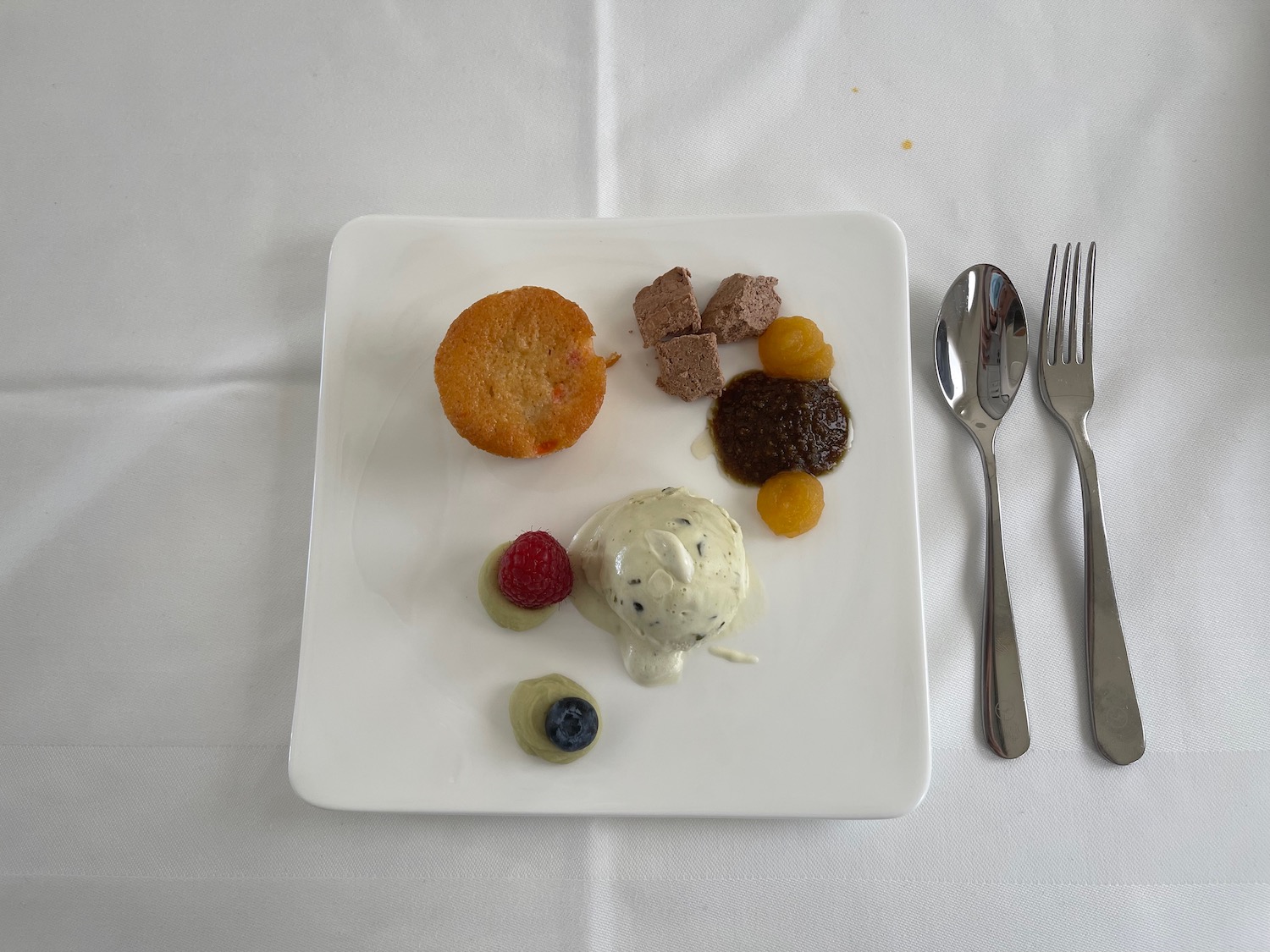 a plate of desserts and spoons