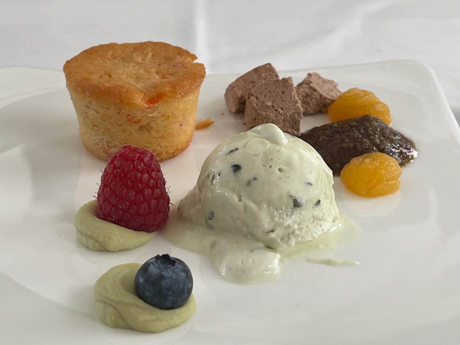 a plate of desserts with ice cream and fruit