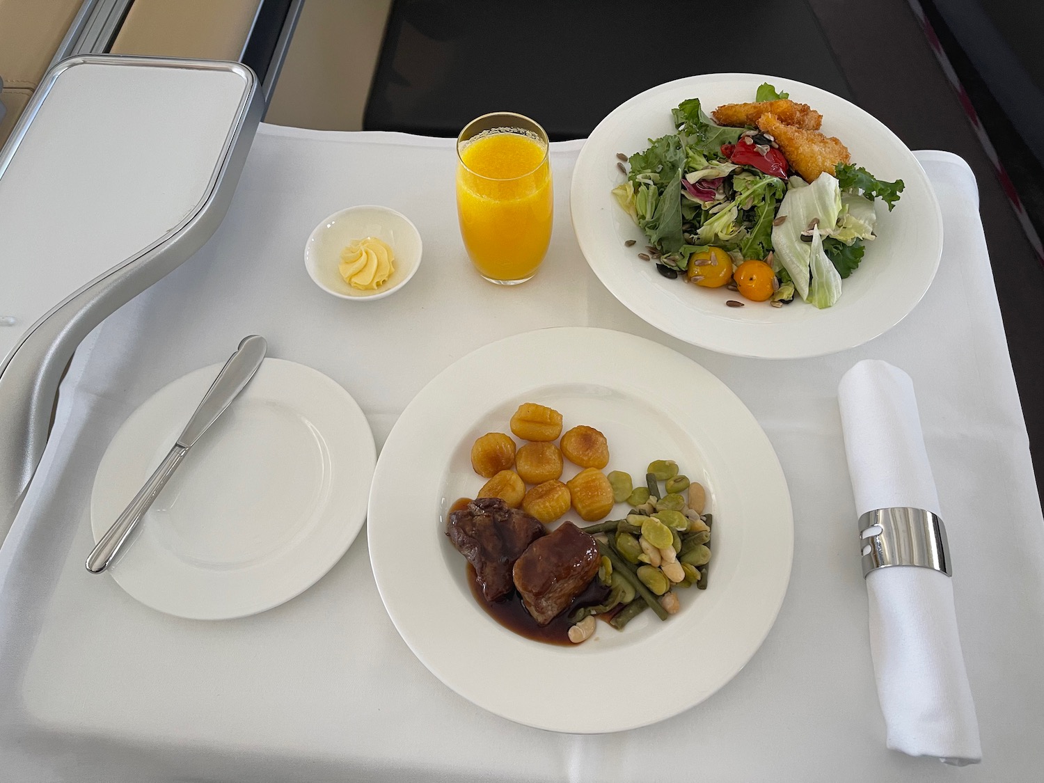 a plate of food and a glass of juice on a table