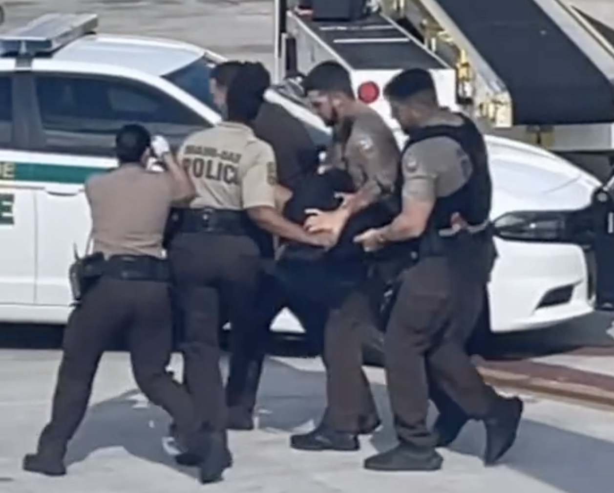a group of police officers carrying a person