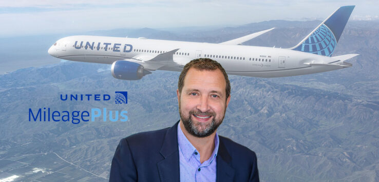 a man in a suit standing in front of a plane