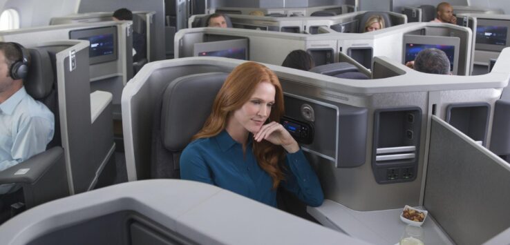 a woman sitting in a chair in an airplane