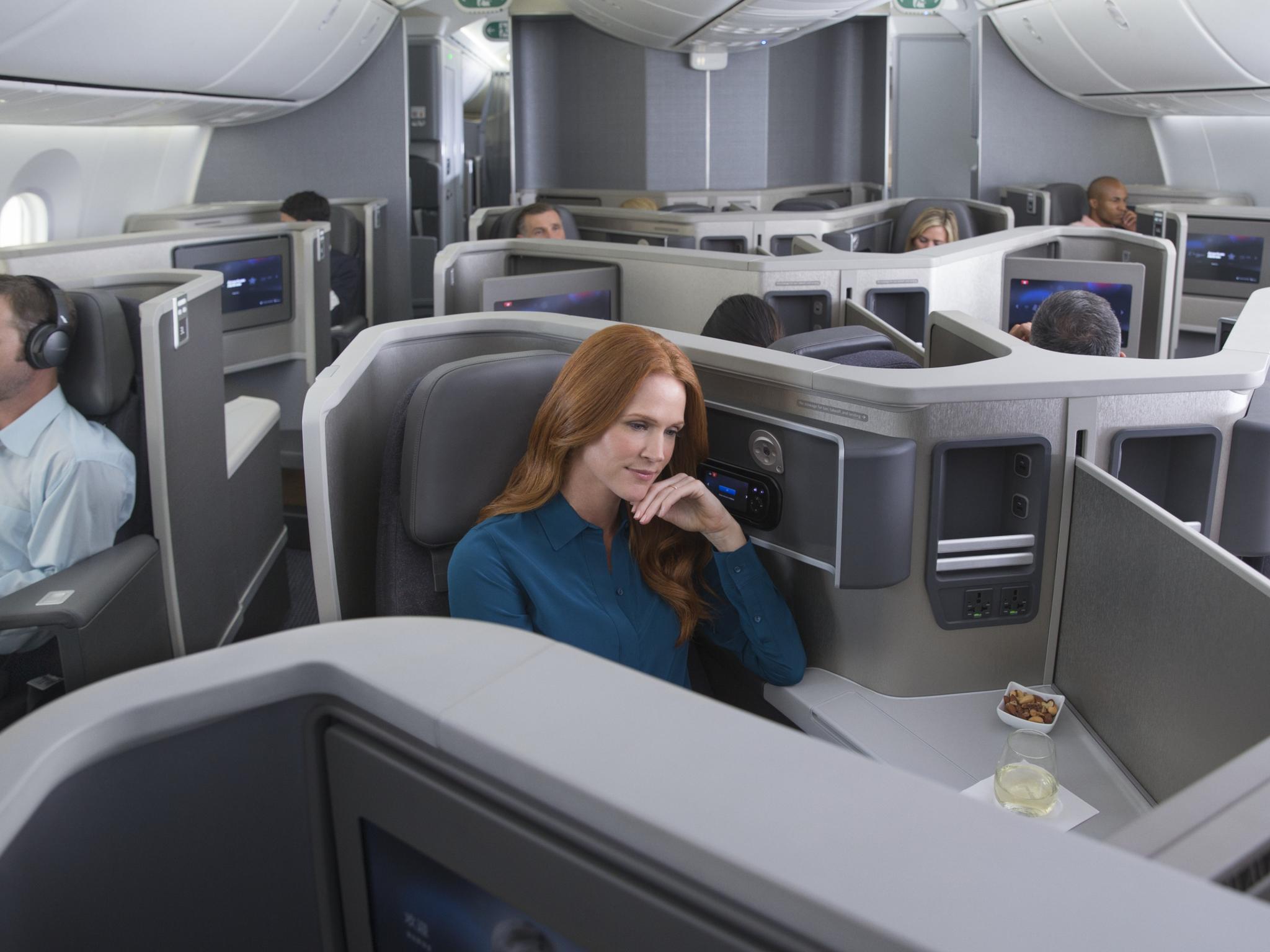 a woman sitting in a chair in an airplane