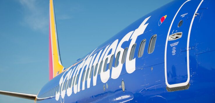 a blue airplane with white writing on it