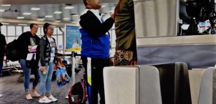 a group of people standing in an airport