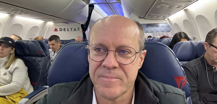 a man taking a selfie in an airplane