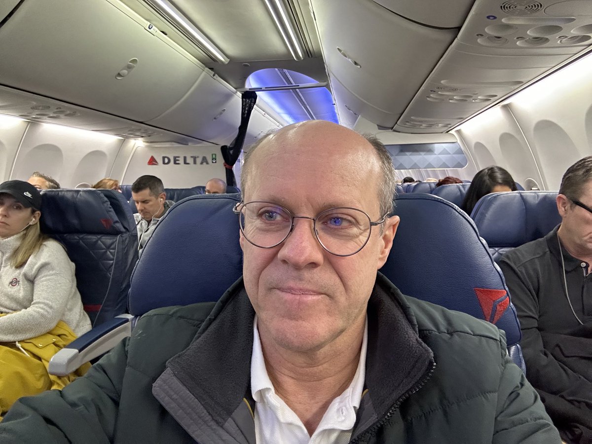 a man taking a selfie in an airplane