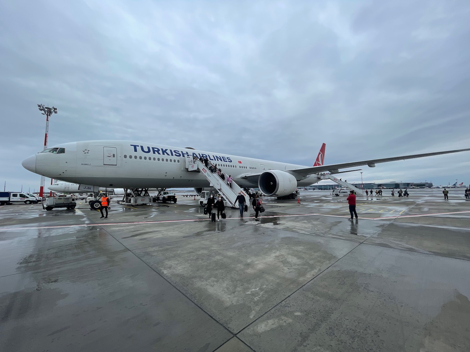 a large airplane with people boarding