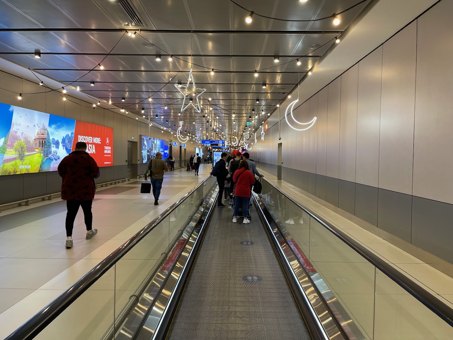 a group of people walking on an escalator