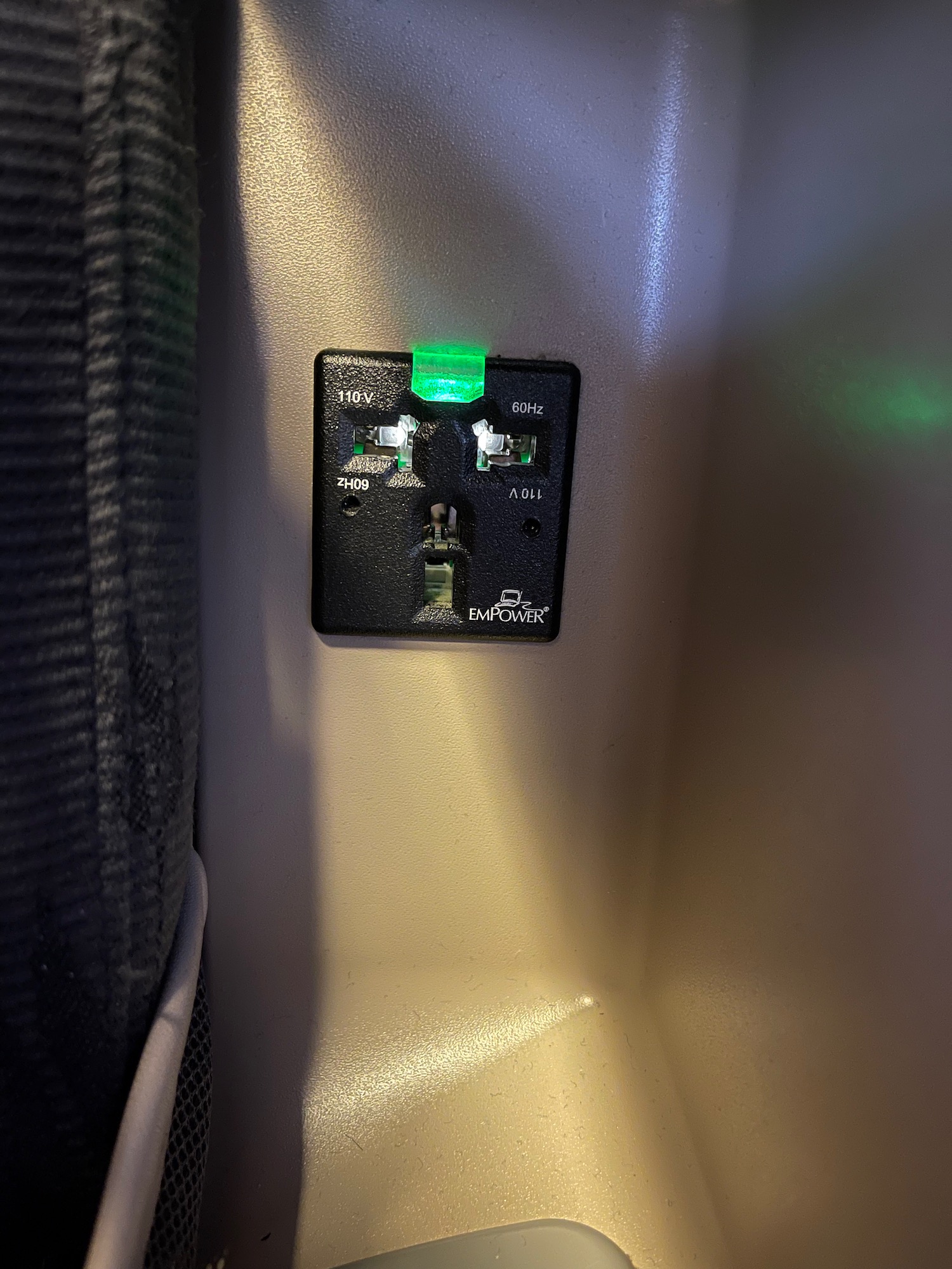 a black rectangular outlet with green lights