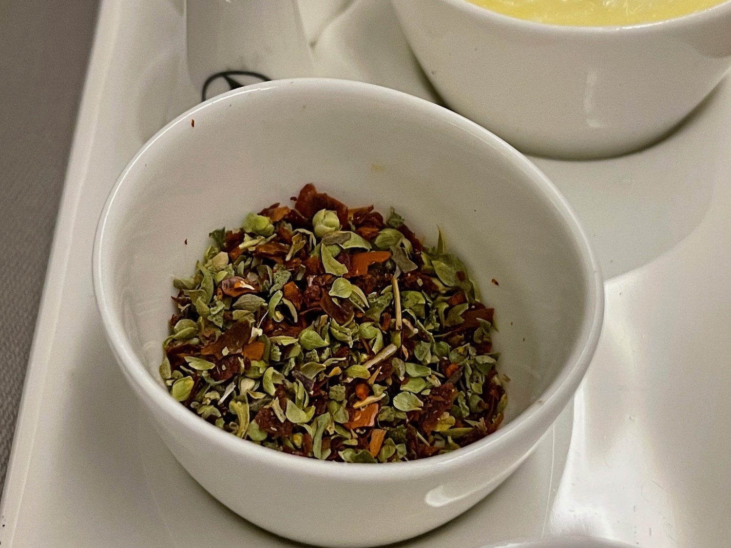 a bowl of spices and a bowl of soup