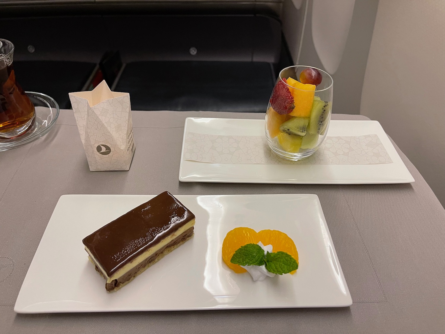 a plate of dessert and fruit on a table