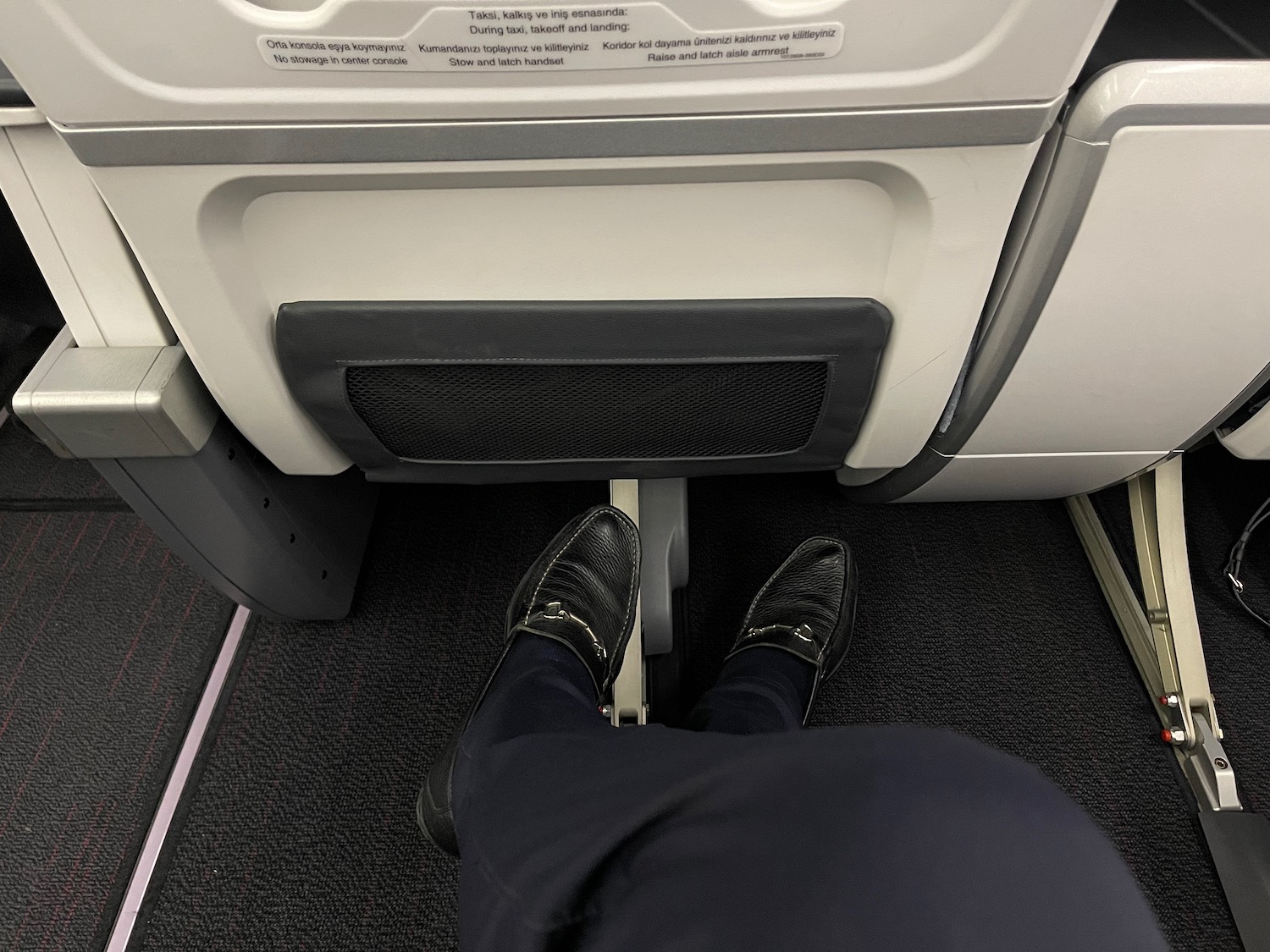 a person's feet in a plane