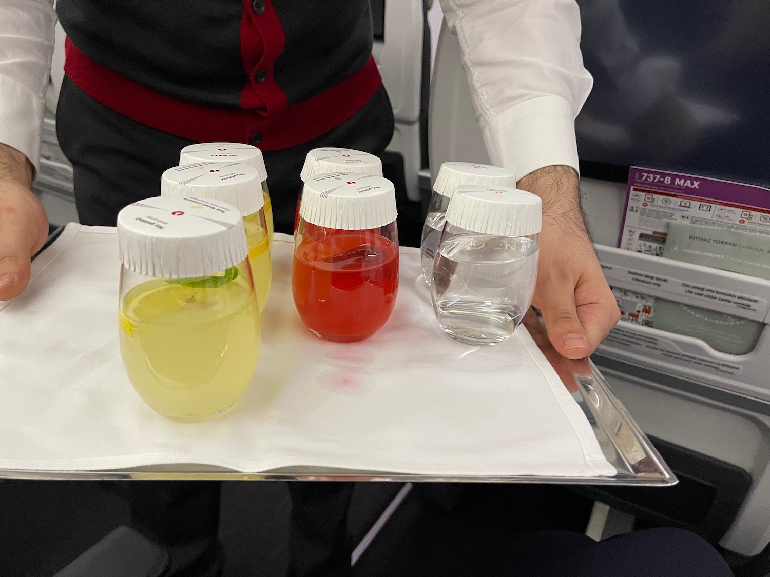 a tray of drinks on a plane