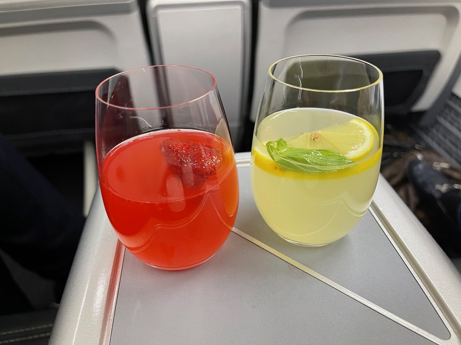 two glasses of different colored drinks