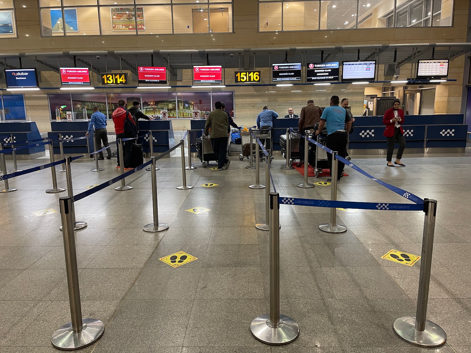 people standing in a line at an airport