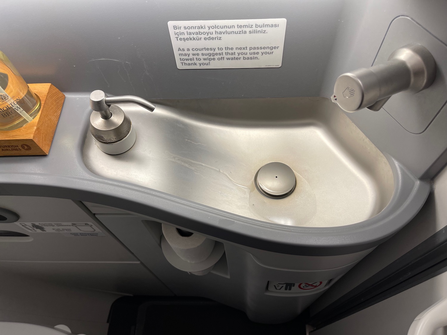 a sink with a paper towel dispenser