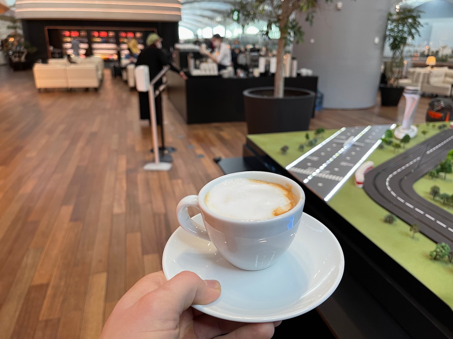 a hand holding a cup of coffee