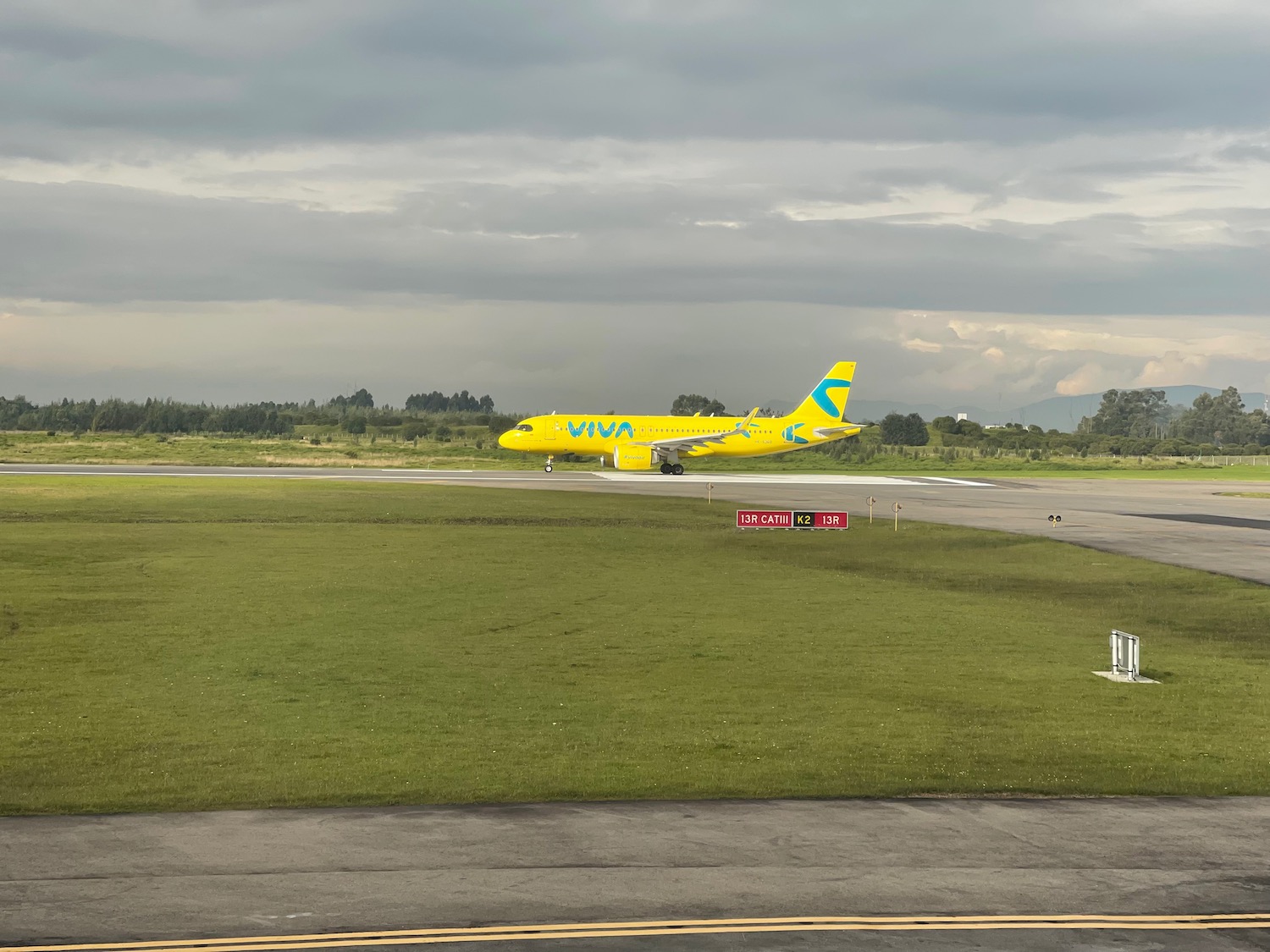 a yellow airplane on a runway