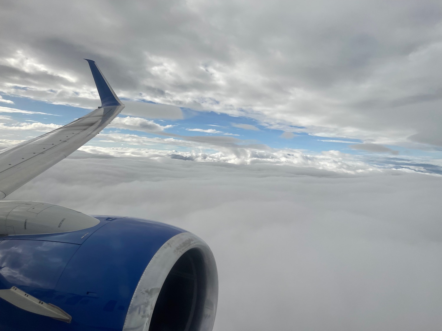 an airplane wing and clouds