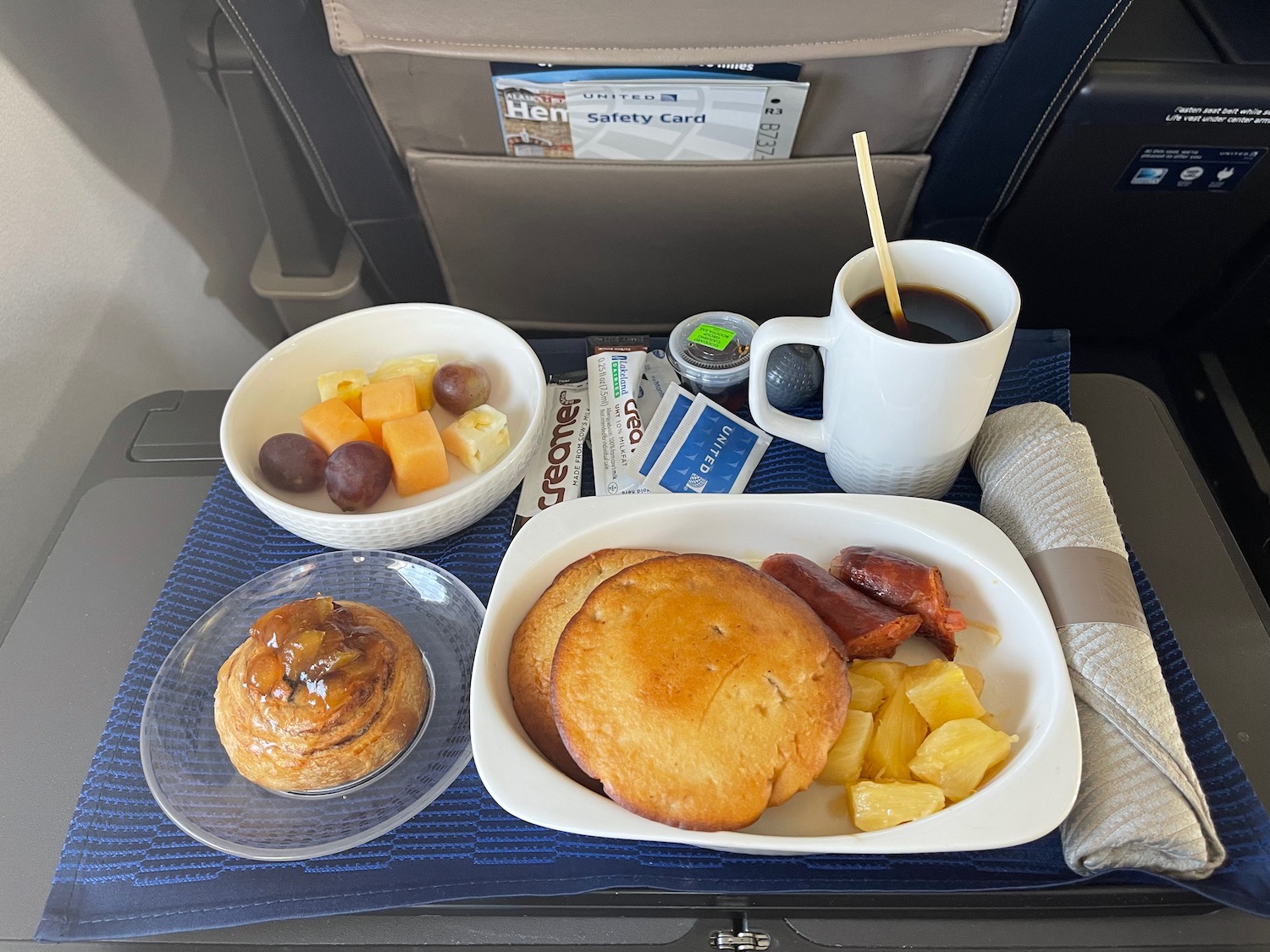 a tray of food and a cup of coffee on a table