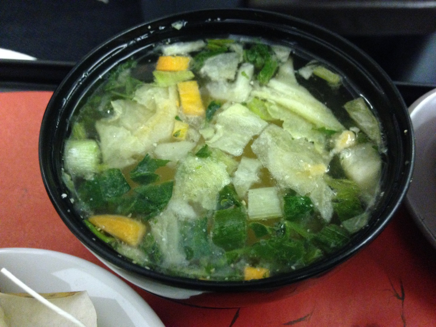 a bowl of soup with vegetables in it