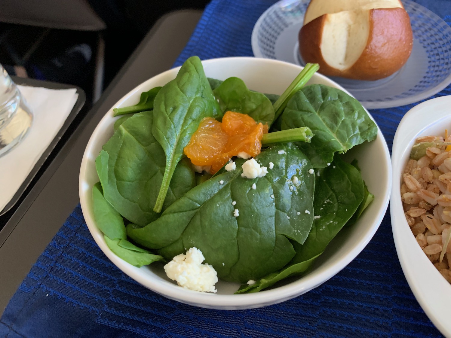 a bowl of spinach and oranges