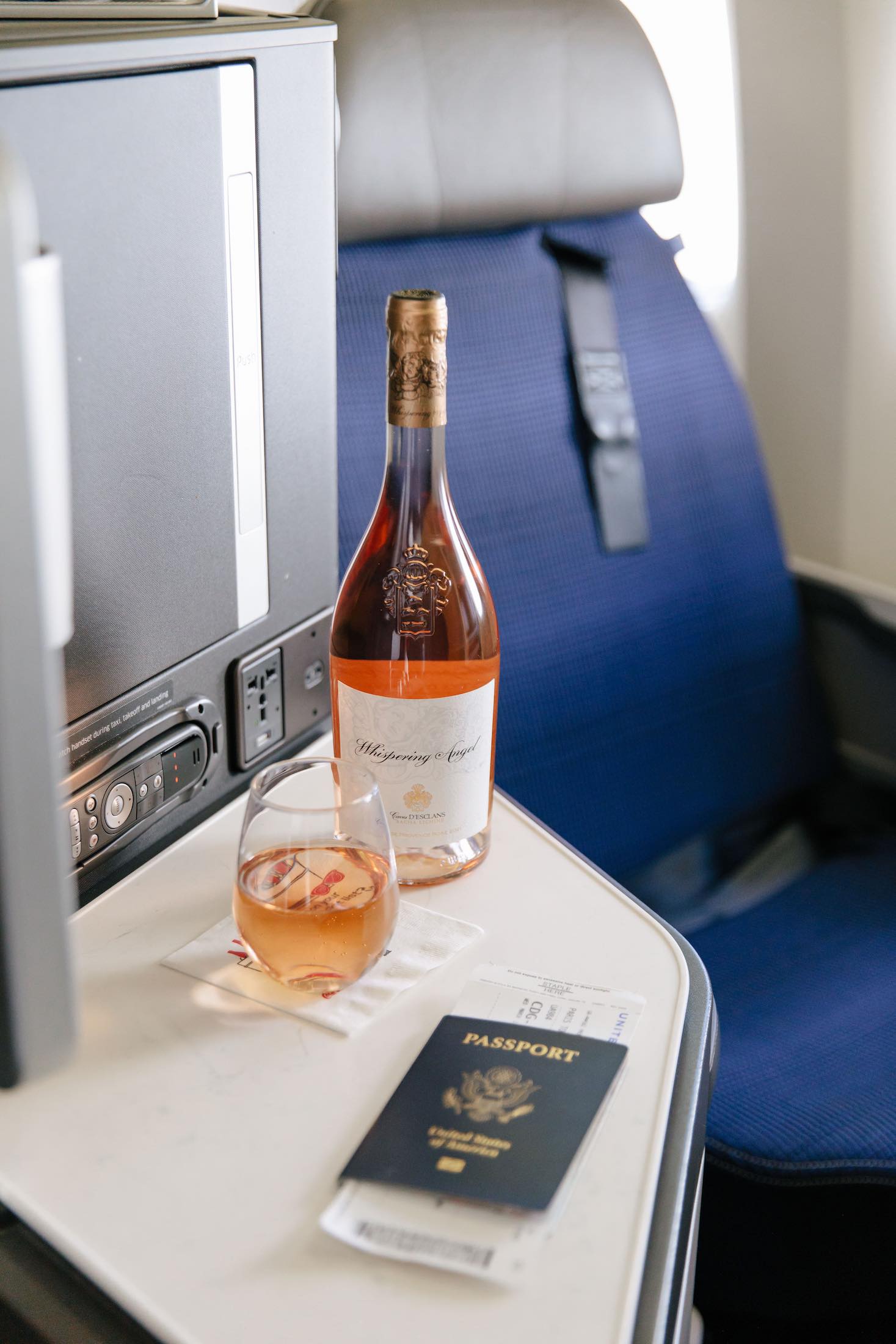 Plastic cup on the table in the plane during the flight. alcohol