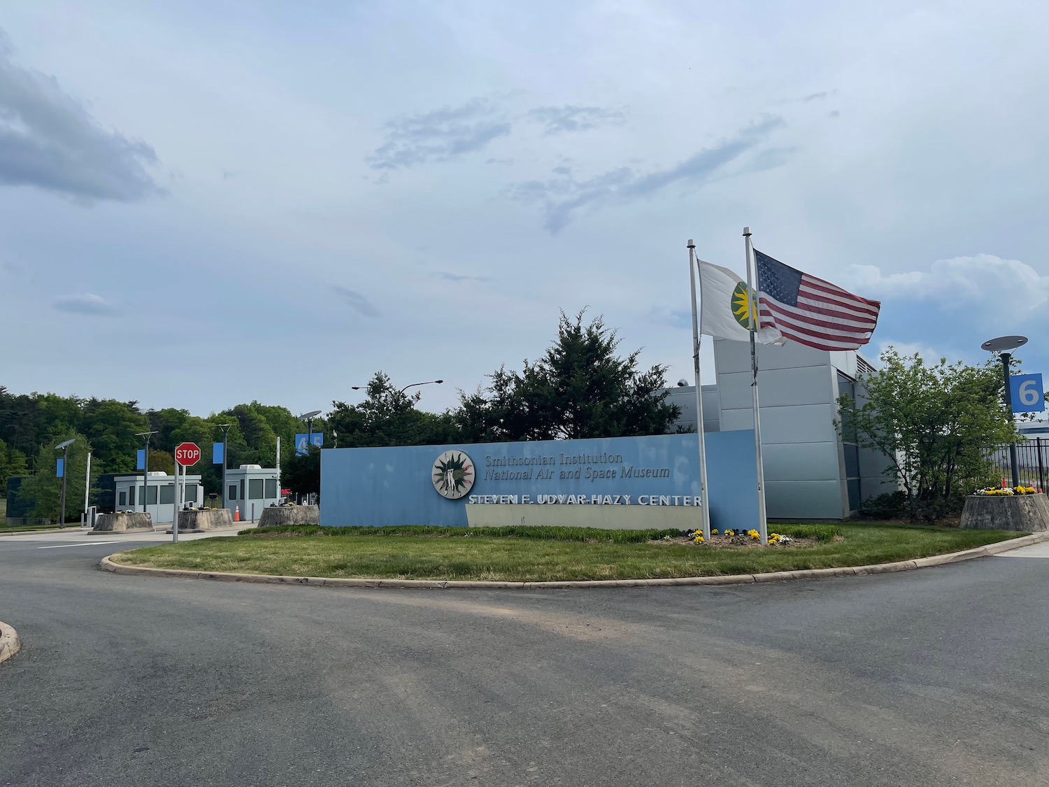 a sign with flags in front of a building