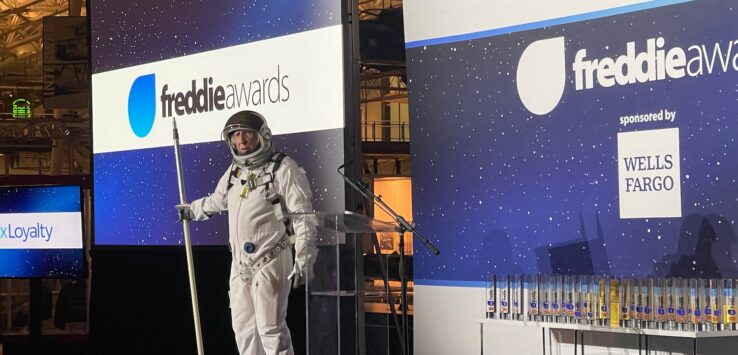 a man in a space suit standing on a podium