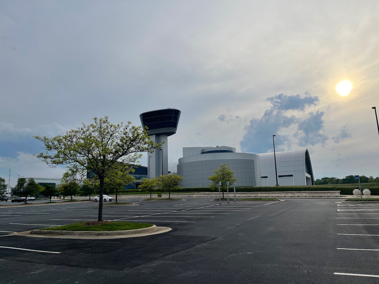 a parking lot with a tower and trees