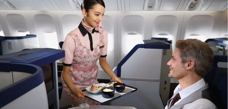 a woman holding a tray with food on it