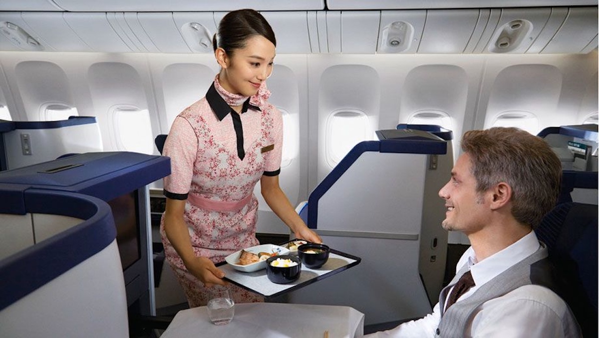 a woman holding a tray with food on it