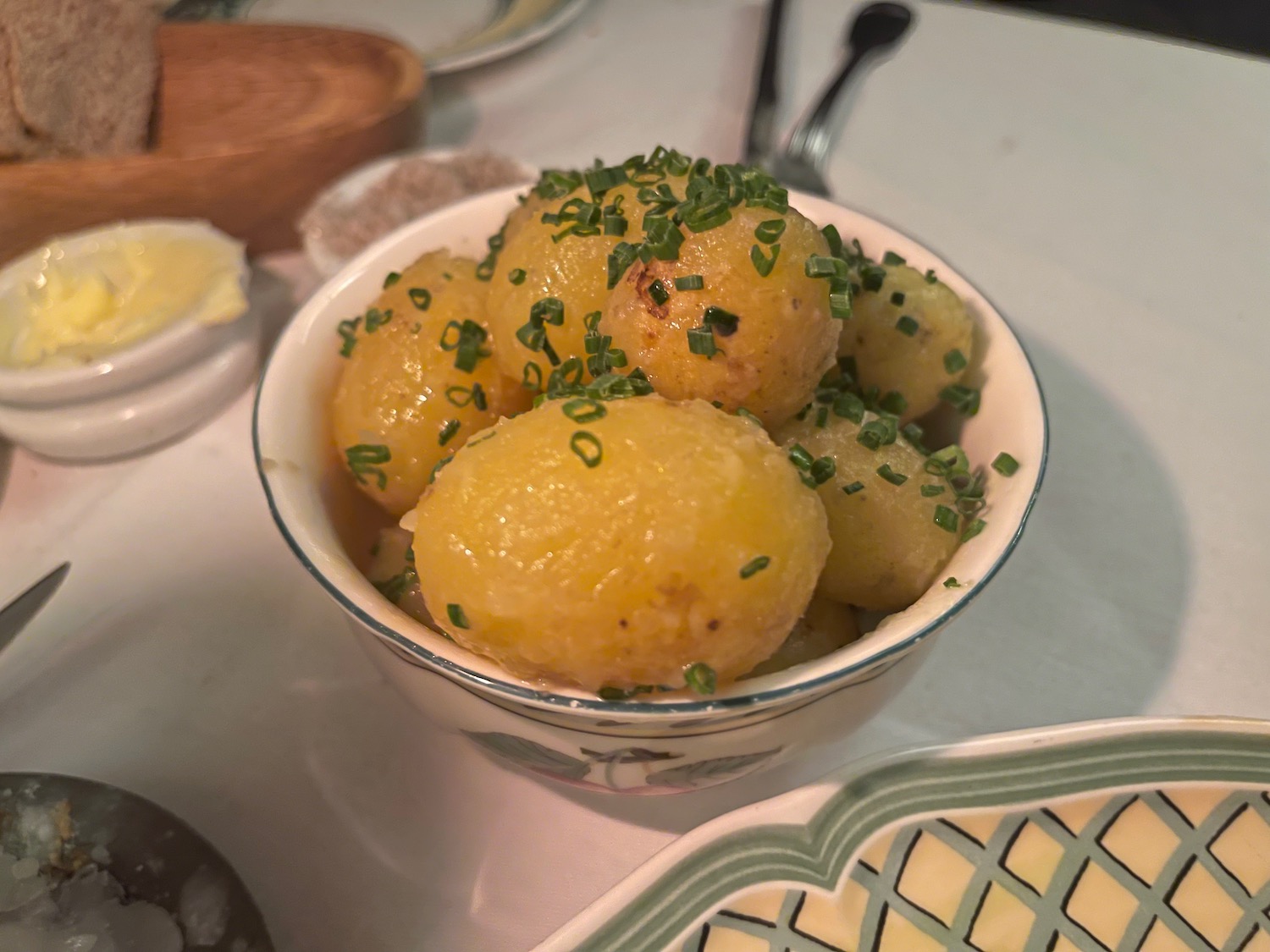 a bowl of potatoes with green onions