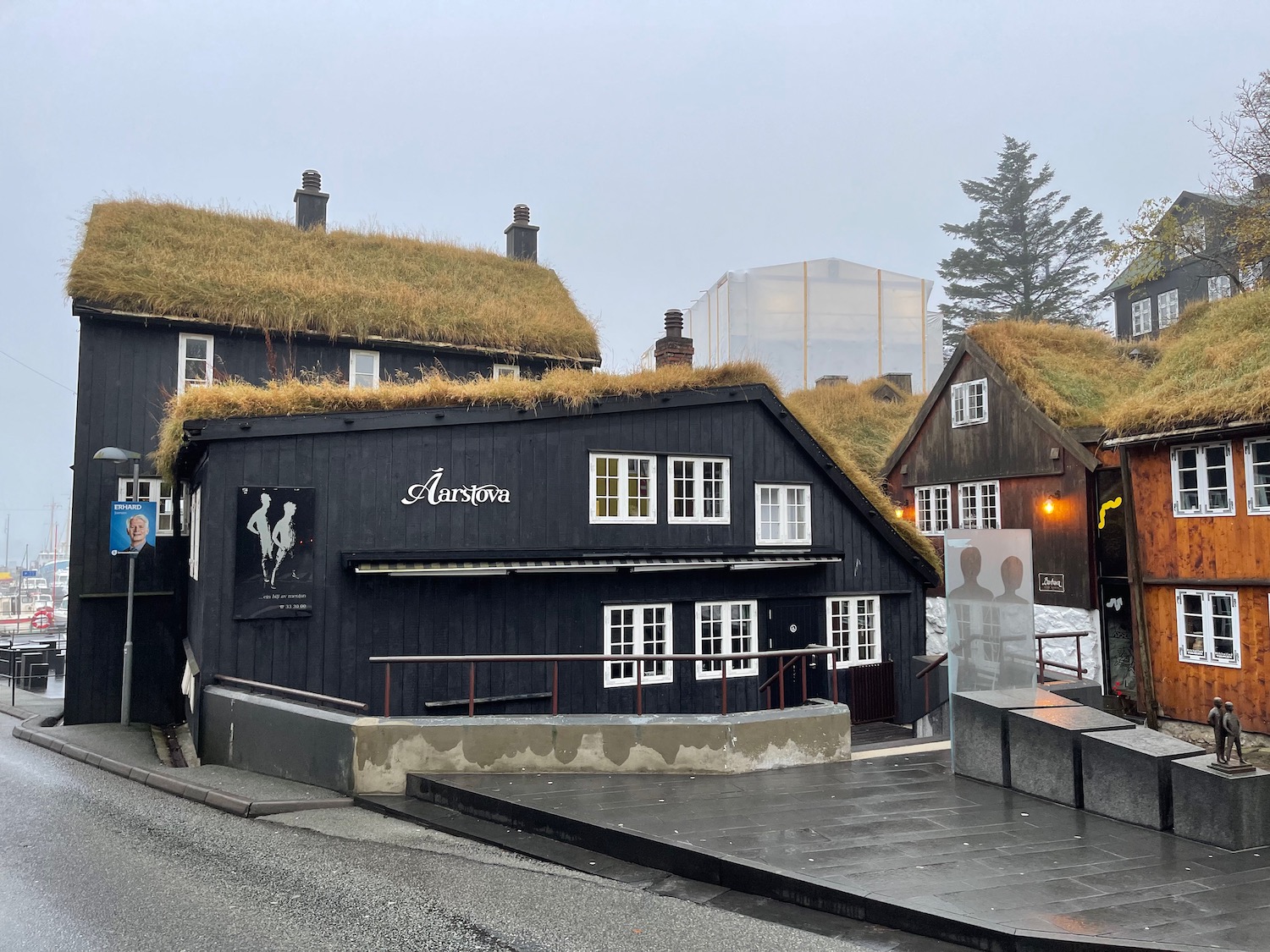 a group of buildings with grass on the roof