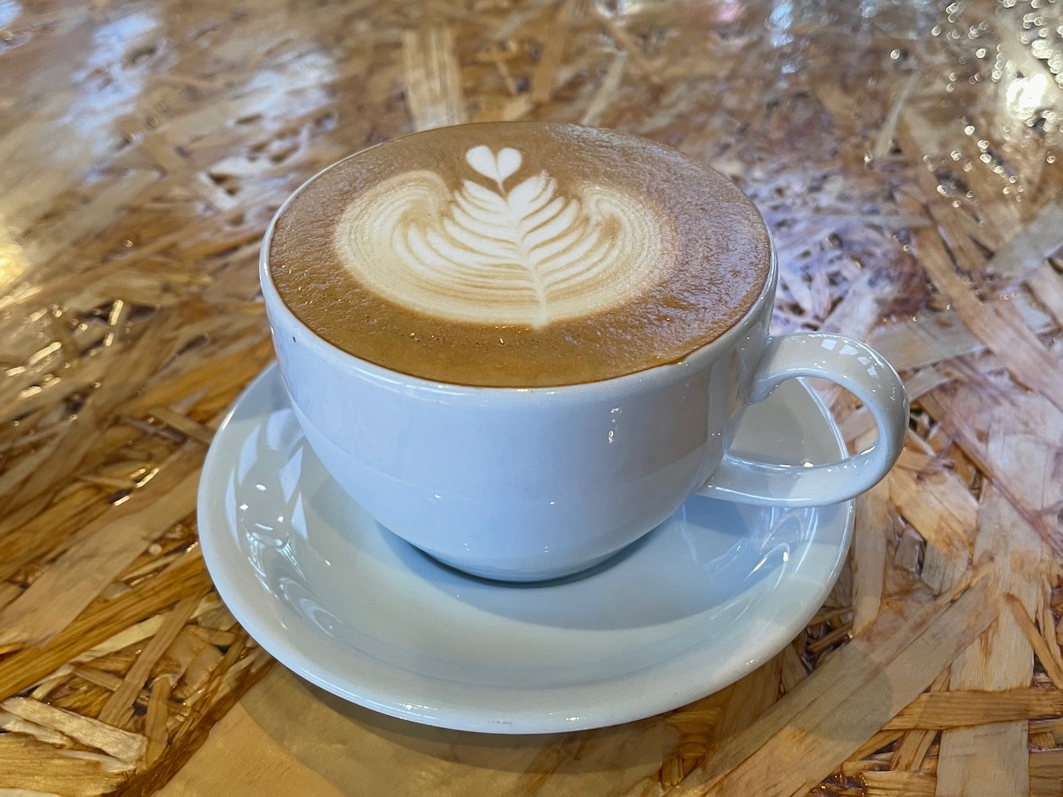 a cup of coffee with a latte art on top