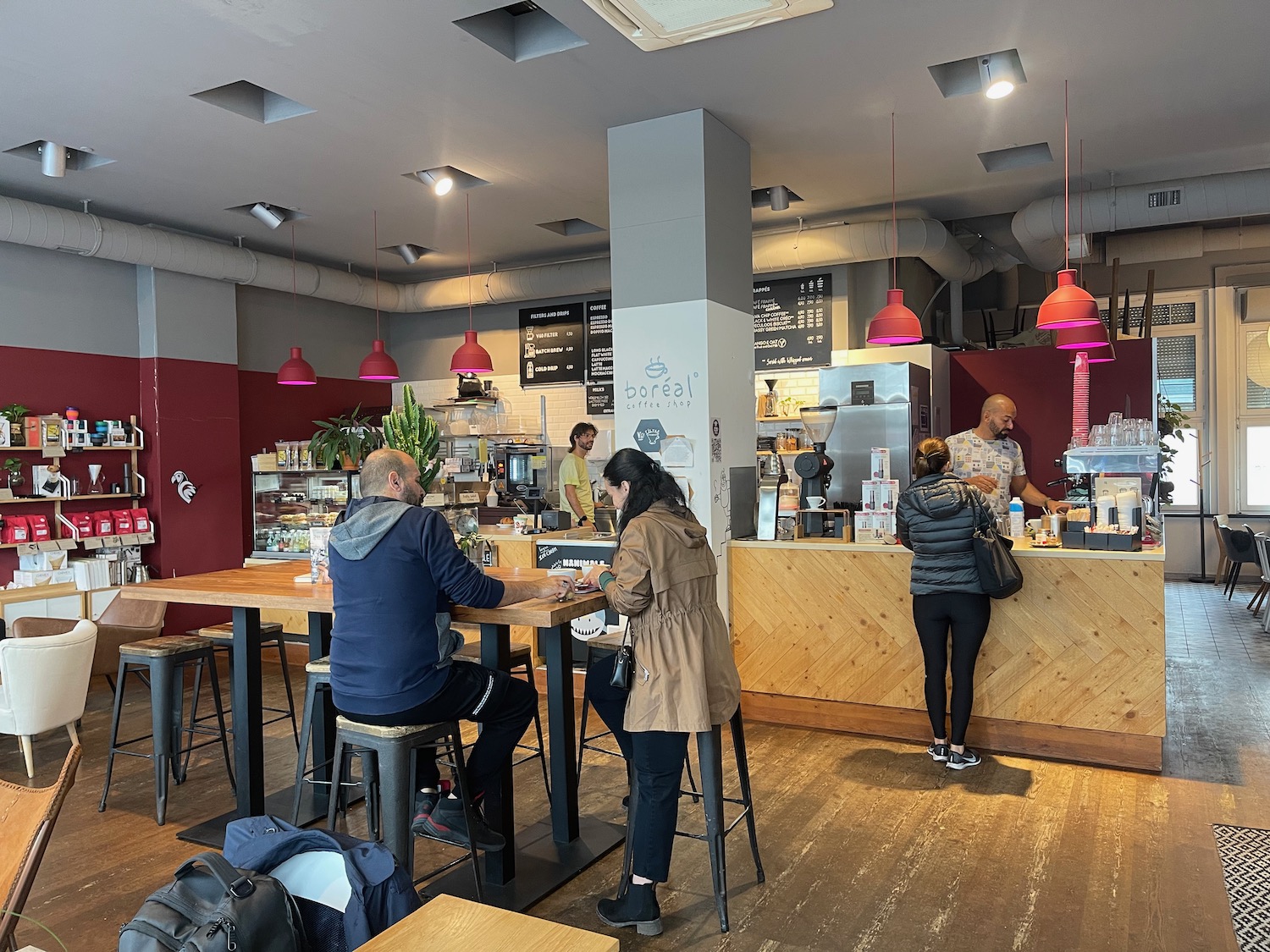 people at a counter in a coffee shop