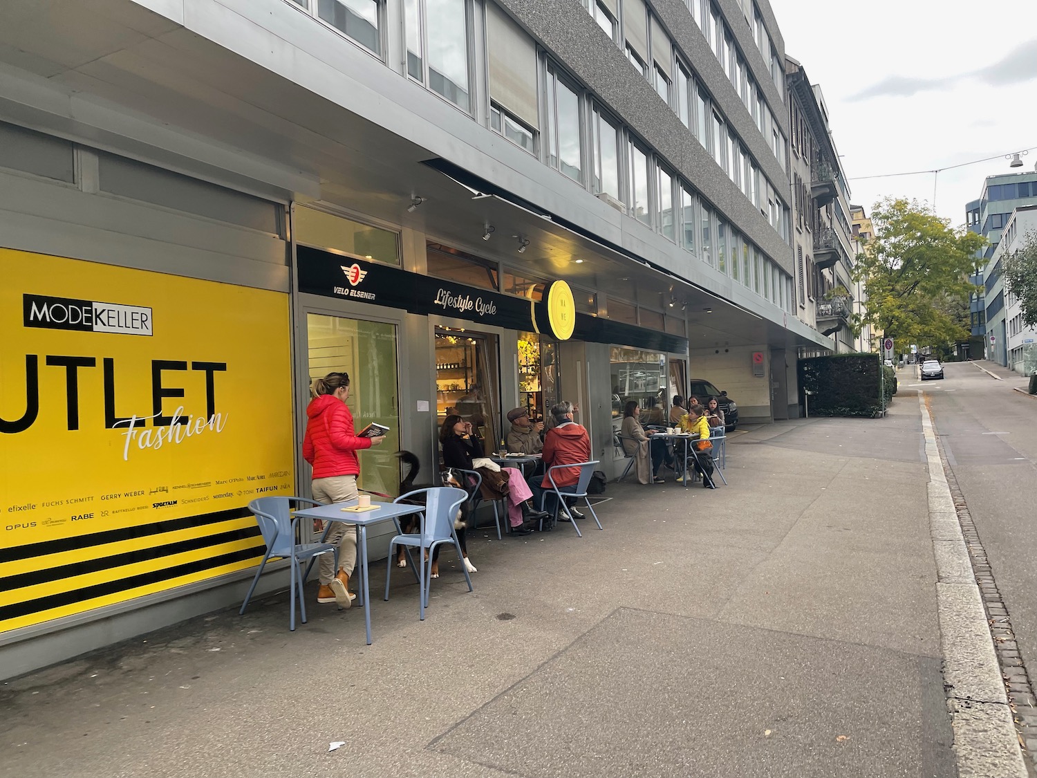 a group of people sitting outside a store